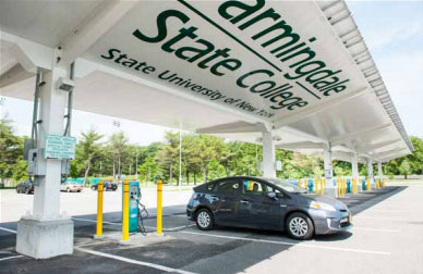 Gray electric vehicle being charged in a FSC parking lot