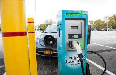 Close-up of a gray electric vehicle being charged in a FSC parking lot