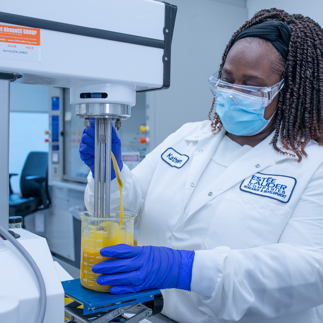 Lab technician mixing ingredients in a mixer